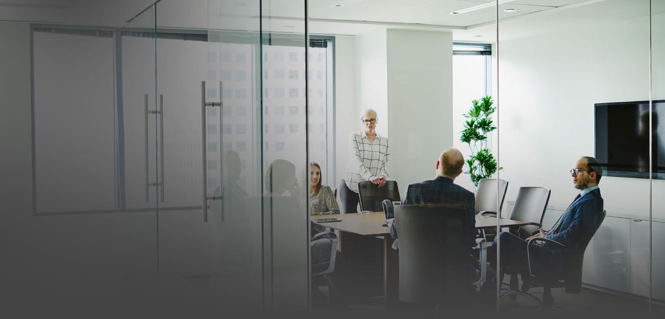 Four people in an office running a board meeting