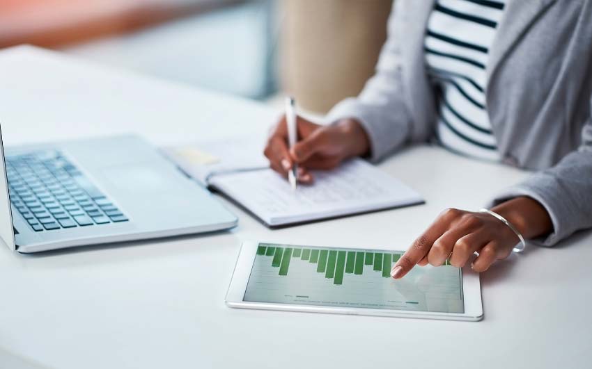 Woman working on laptop and tablet