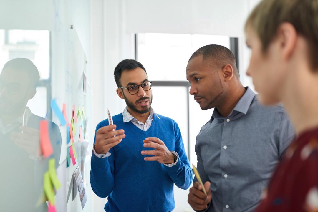 Colleagues within an organization following the 21 step succession planning checklist