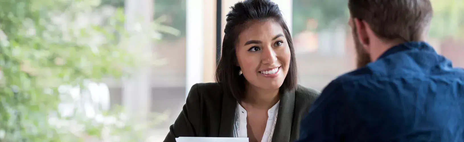 Two professionals discussing how to optimize audit efficiency.