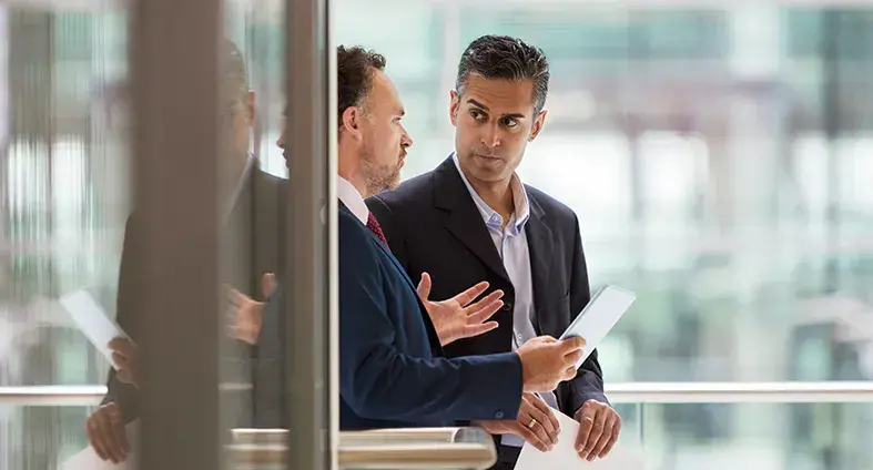 internal auditor and first-line control owner discussing control assessments