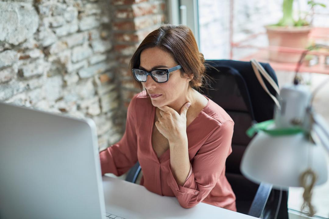 Image of woman researching the definition of regulatory compliance and requirements.